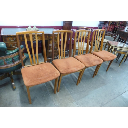 79 - A set of four teak dining chairs