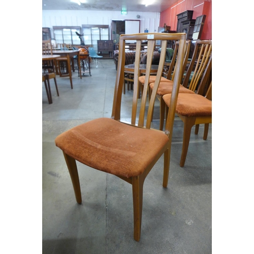 79 - A set of four teak dining chairs