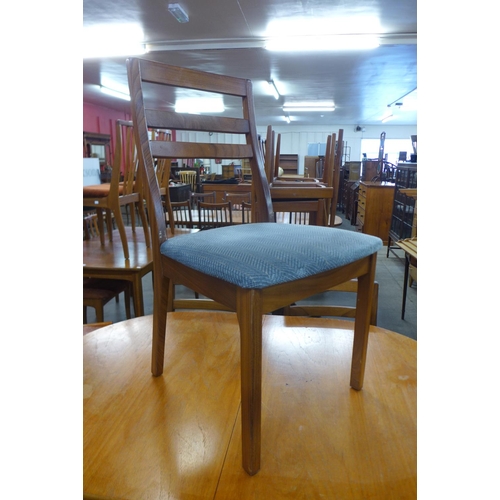 89 - A Nathan teak extending dining table and four chairs