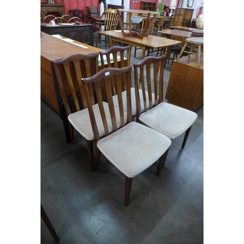 94 - A set of four teak dining chairs