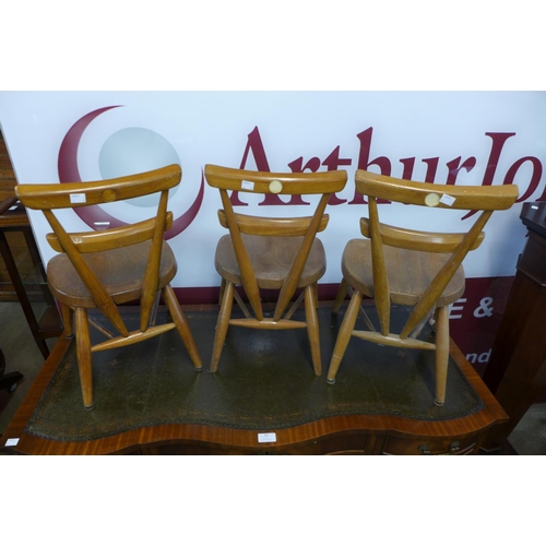 96 - A set of three Ercol child's elm and beech yellow dot stacking chairs