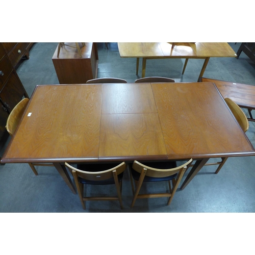 97 - A teak extending dining table and six chairs