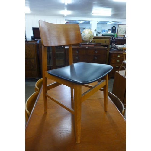 97 - A teak extending dining table and six chairs