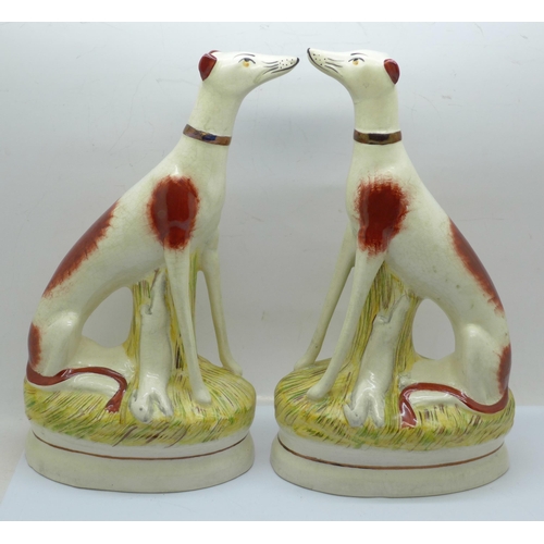 619 - Two Staffordshire pottery sitting greyhounds, 23cm