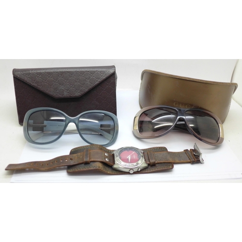 623 - Two pairs of lady's Gucci sunglasses, cased and a Fossil wristwatch