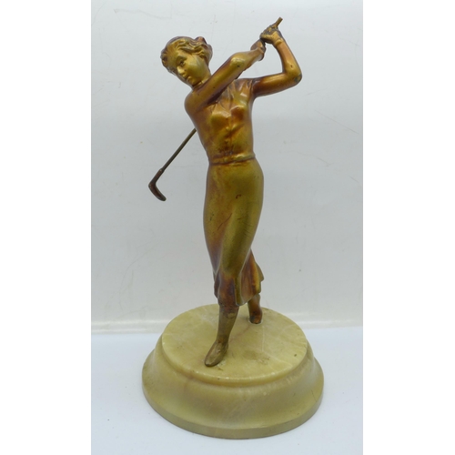 646 - A 1930's Art Deco Lorenzl figure of a golfer, on a circular base, restored/repaired on the left leg,... 