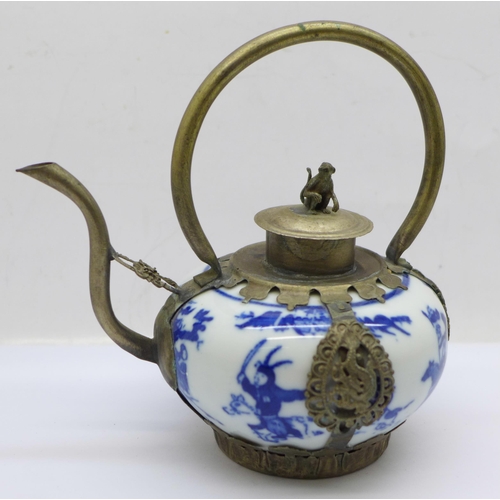 651 - A small Chinese blue and white metal framed teapot