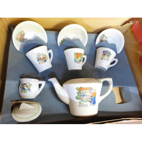 689 - A collection of Wedgwood Peter Rabbit children's mugs and plates and a boxed set of nursery tea ware... 