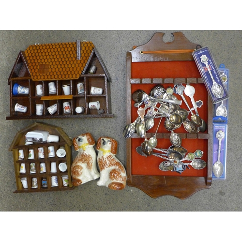 701 - A collection of spoons and thimbles, two display stands, and a pair of Staffordshire spaniels, one a... 