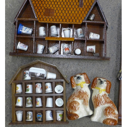 701 - A collection of spoons and thimbles, two display stands, and a pair of Staffordshire spaniels, one a... 