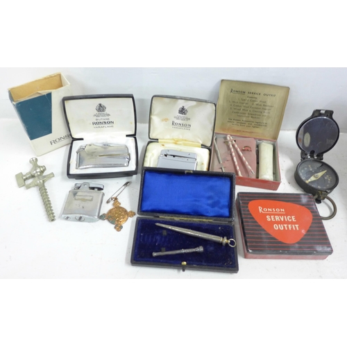 724 - A WWI period compass, three Ronson lighters and two service outfit tins, pipe reamer, silver pencil,... 
