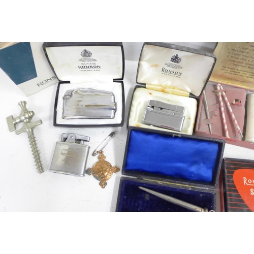 724 - A WWI period compass, three Ronson lighters and two service outfit tins, pipe reamer, silver pencil,... 