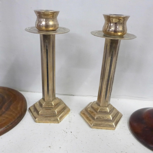 748 - Four pairs of candlesticks including a bronze pair and two others in a wicker basket