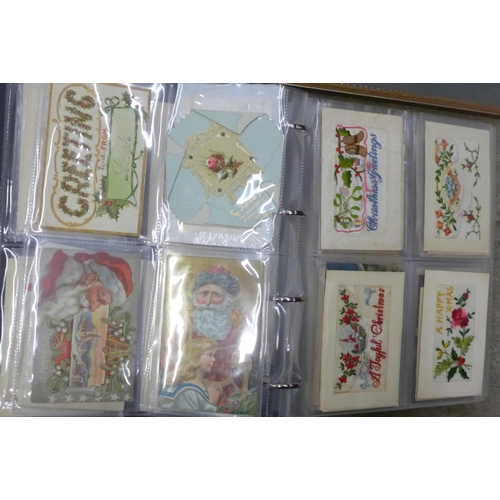 757 - An album of silk and needlework postcards and two framed sets