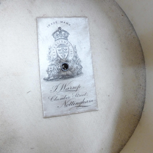 791 - A top hat, marked J. Warsop, Nottingham, in a leather hat box, inner rim requires repair