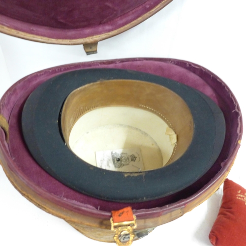 791 - A top hat, marked J. Warsop, Nottingham, in a leather hat box, inner rim requires repair