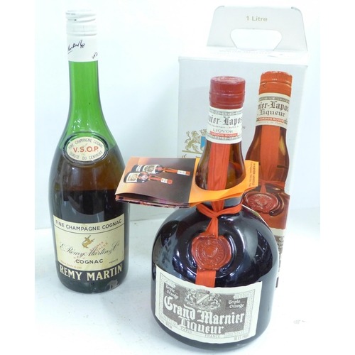 821 - A bottle of Grand Marnier and a bottle of Remy Martin, and two empty bottles