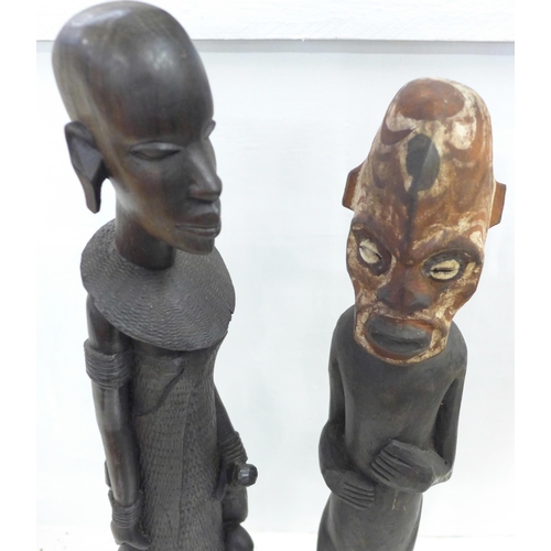 825 - Two carved African figures, a drum and a knife