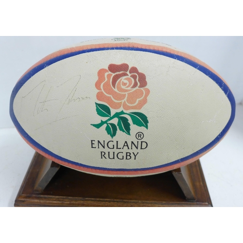 832 - An England Rugby ball, signed by Martin Johnson and two promotional black and white photographs of J... 