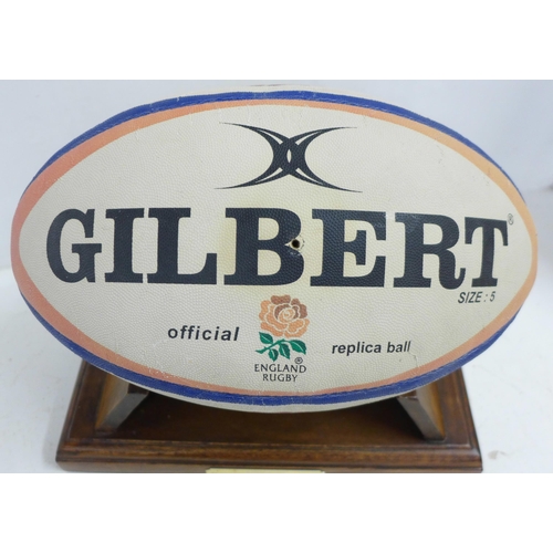 832 - An England Rugby ball, signed by Martin Johnson and two promotional black and white photographs of J... 