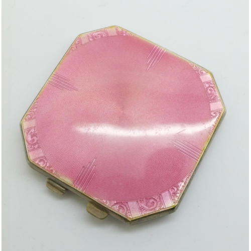 887 - A pink enamelled silver compact with mirror and powder puff, Birmingham 1941, small chip on the enam... 