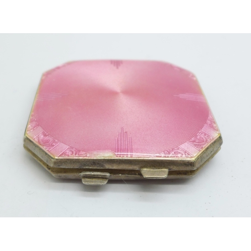 887 - A pink enamelled silver compact with mirror and powder puff, Birmingham 1941, small chip on the enam... 