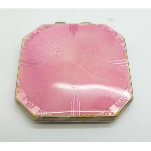 887 - A pink enamelled silver compact with mirror and powder puff, Birmingham 1941, small chip on the enam... 