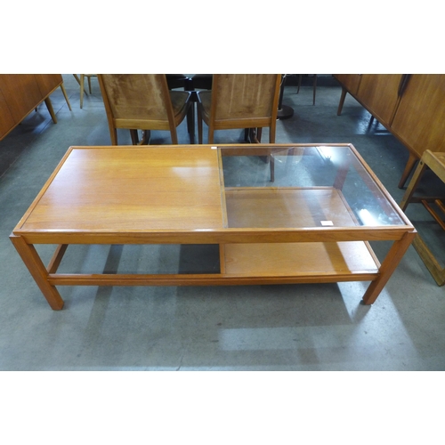 111 - A teak and glass topped coffee table