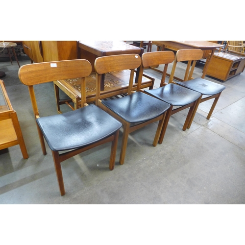 117 - A set of four teak and black vinyl dining chairs