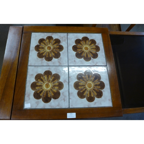121 - A teak, glass and tiled topped coffee table
