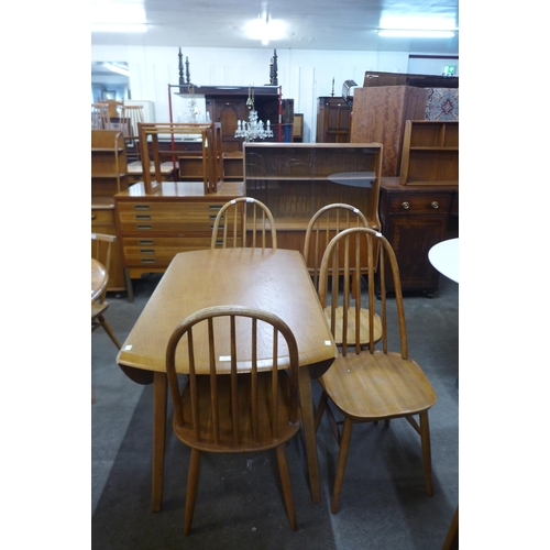 125 - A Priory oak drop-leaf table and four chairs