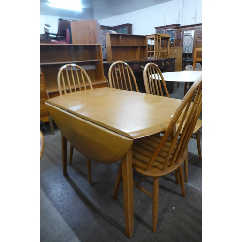 125 - A Priory oak drop-leaf table and four chairs