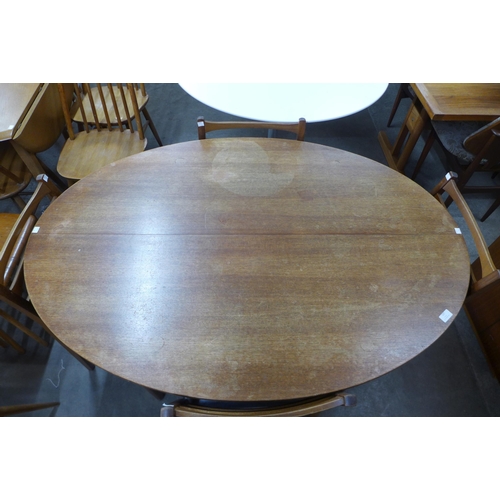 127 - A Greaves & Thomas teak extending dining table and four chairs