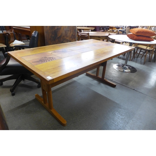 133 - A Danish teak and tiled topped dining table, by A.M. Mobler