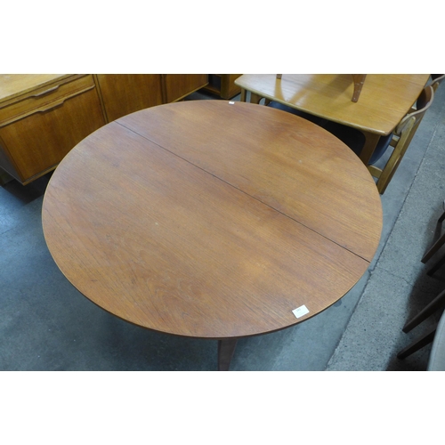 143 - A teak extending dining table