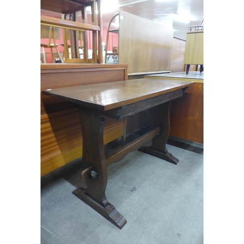 173 - A Cotswold School oak single drawer writing table