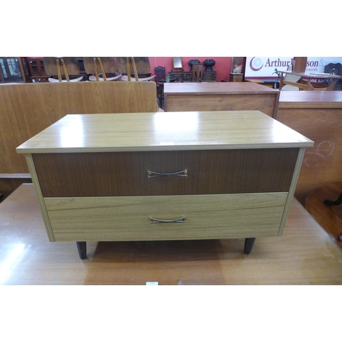 175 - A simulated teak and tola wood chest of drawers