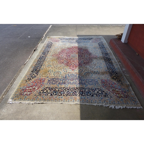 275 - A large beige ground rug