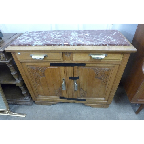 279 - A carved oak and marble topped sideboard