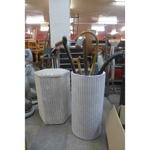 325 - Two Lloyd Loom linen baskets and assorted walking canes