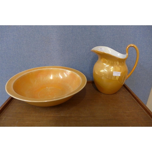 339 - An orange lustre wash jug and bowl