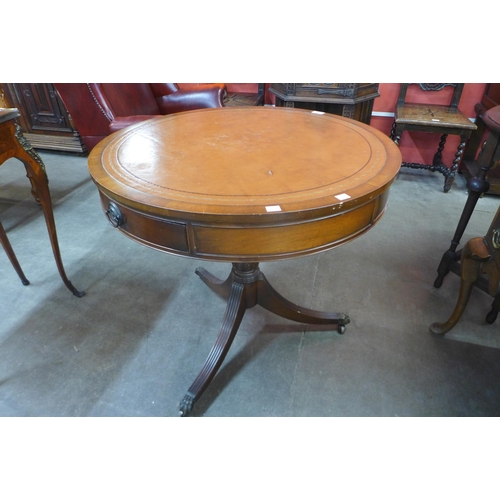 41 - A Regency style mahogany and leather topped drum shaped table