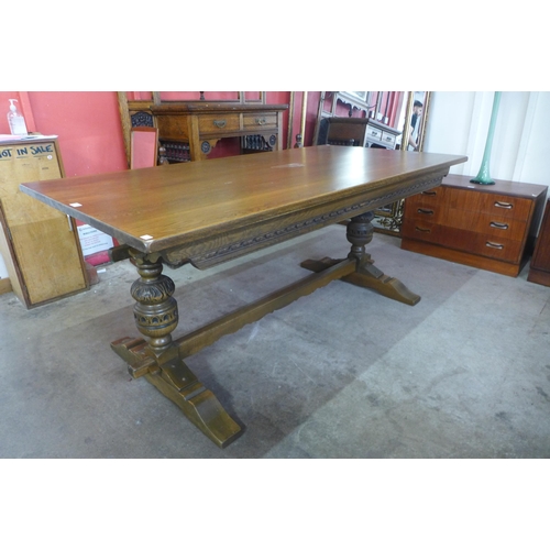 61 - An 18th century style carved oak refectory table