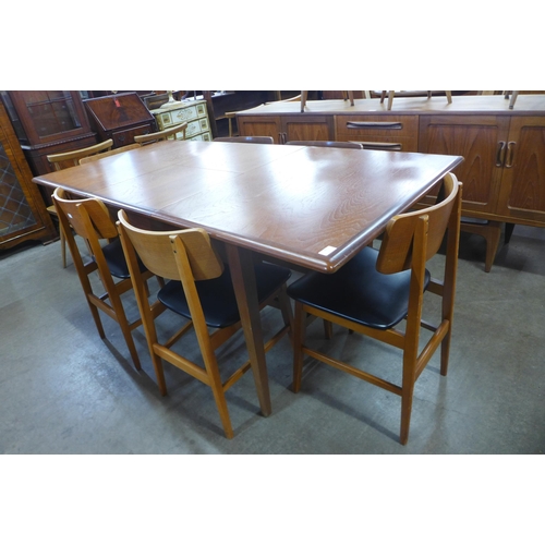 96 - A teak extending dining table and six chairs