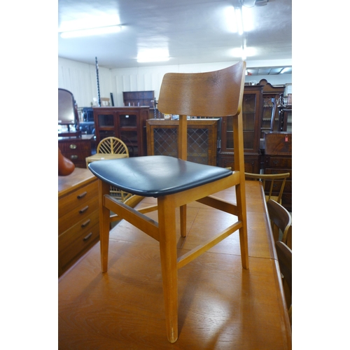 96 - A teak extending dining table and six chairs