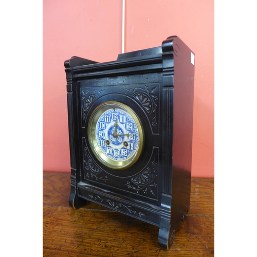 21 - A Victorian Aesthetic Movement ebonised bracket clock