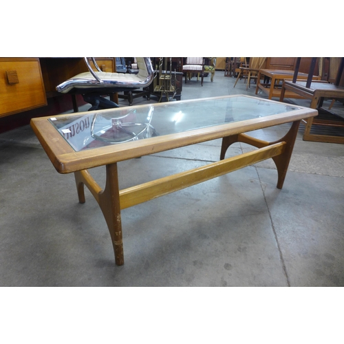 104 - A Stonehill Stateroom teak and glass topped coffee table