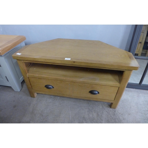 1493 - A Rutland oak corner TV unit, damaged joints, marked (RAO-CTV) * this lot is subject to VAT