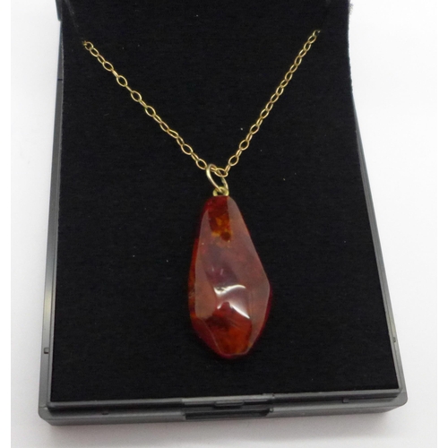 1007 - An amber pendant on a fine chain marked 375 on bolt ring, chain 1g