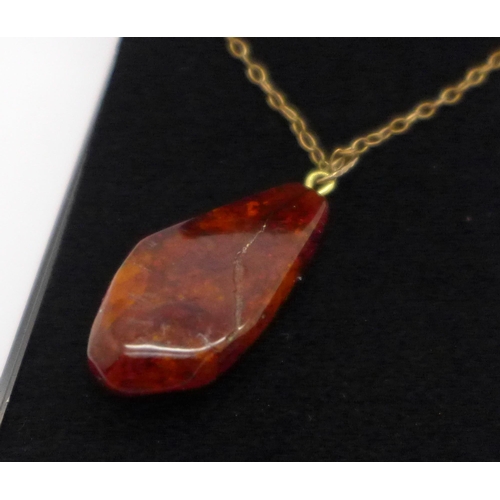 1007 - An amber pendant on a fine chain marked 375 on bolt ring, chain 1g